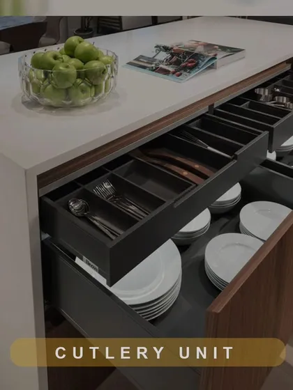 Our multi-layered cutlery units are a masterclass in organization. This image shows a deep drawer with separate compartments for plates, bowls, and cutlery, keeping your dinnerware secure and orderly.