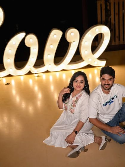 A casual and fun photo with our large illuminated 'Love' sign, perfect for a relaxed pre-wedding shoot.