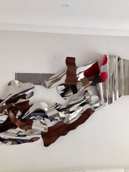 Another view of the large-scale abstract wall sculpture, highlighting its different materials and textures.
