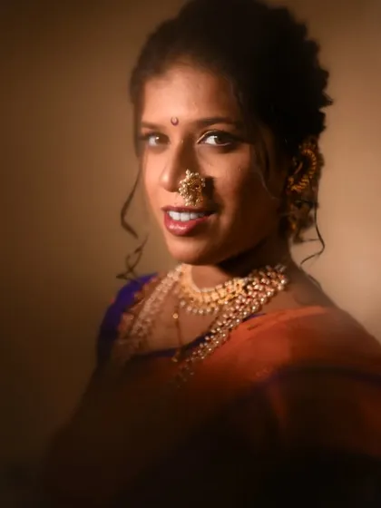 A warm, smiling portrait of the bride looking directly at the camera, her happiness shining through.