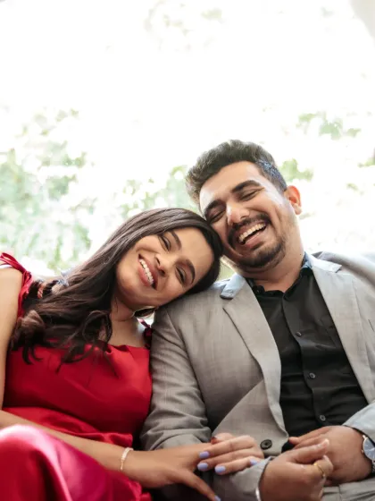 An intimate close-up filled with genuine laughter and affection. This candid shot focuses on the pure, unposed emotion between the couple, showcasing the real connection that is the heart of their story.