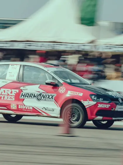 A Volkswagen Polo rally car, complete with MRF Tyres and Harmonixx branding, at speed. Our event welcomes vehicles from various motorsport disciplines.