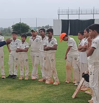 A coach provides tactical instruction to our U-12 players during a break in play. We believe in developing game awareness and strategic thinking from a young age.
