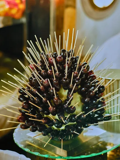 A stunning 'grape porcupine' fruit sculpture. This creative presentation is a conversation starter and a testament to our team's artistic flair.