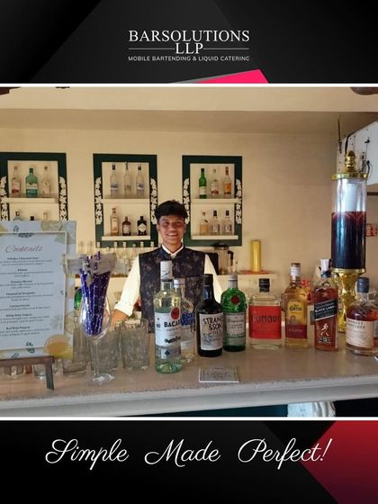 A classic bar setup for a house party, showcasing a full range of spirits and a custom cocktail menu.