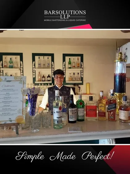 A classic bar setup for a house party, showcasing a full range of spirits and a custom cocktail menu.