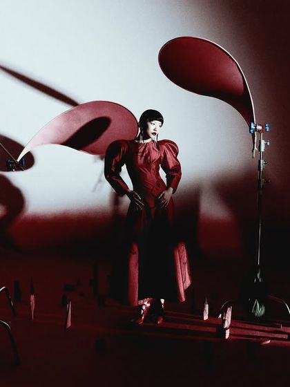 A wide shot that reveals the set design and lighting setup. This behind-the-scenes perspective shows the process of creating the final, polished image.