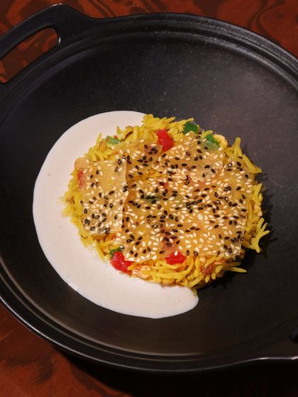 Another view of our Chawal ka Zarda, showcasing the delicate sesame crisp layered over the saffron-infused sweet rice. It's a unique and satisfying end to any meal.