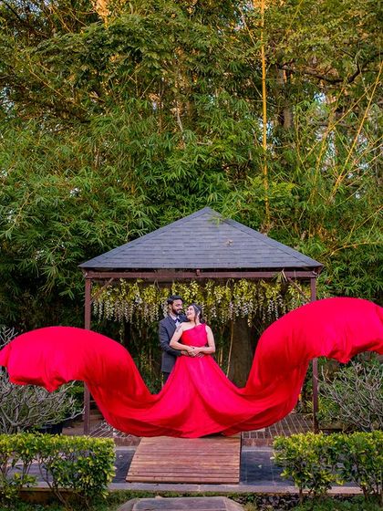 A similar shot with a flowing red gown, showcasing the versatility of the backdrop.