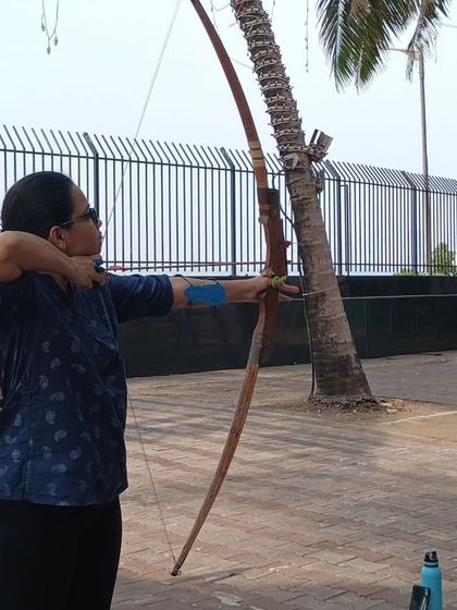 An adult student takes aim during an outdoor session. The calm and focused environment helps archers connect with their technique.
