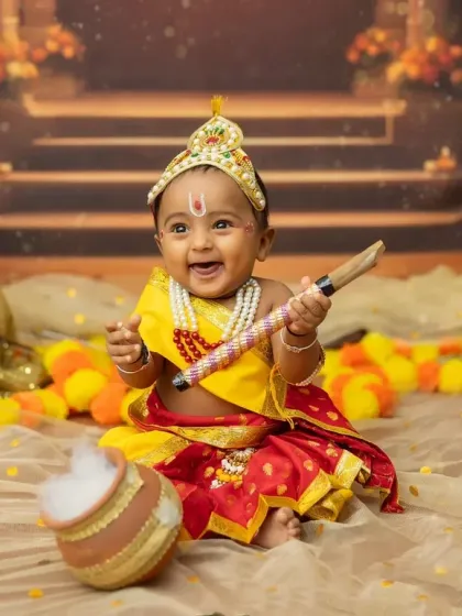 Another big, happy smile from our little Krishna. These sitter sessions are perfect for capturing such expressive moments.