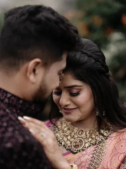 An intimate close up, focusing on the bride's serene expression as the groom holds her. This photo is all about quiet emotion and connection.