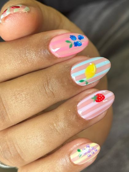 This set is ripe for compliments. A super cute design with tiny, hand-painted fruits like strawberries and lemons on a pastel striped background. Perfect for short nails.