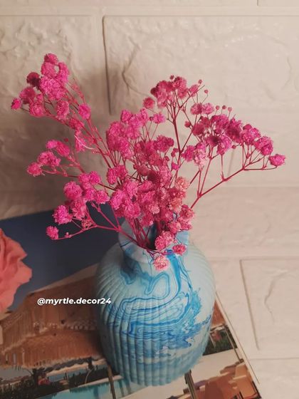 A closer shot of the flowers in our blue marbled vase. The ribbed texture of the vase adds another layer of visual interest.