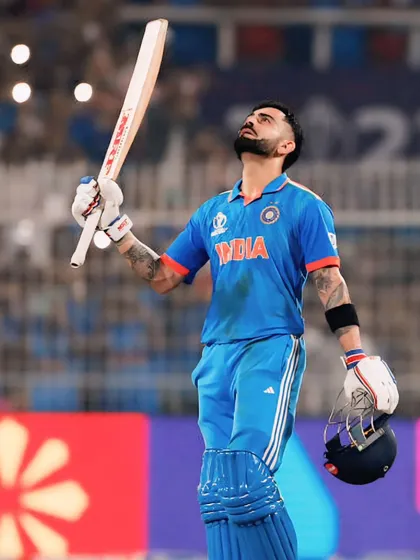 A moment of gratitude and relief from Virat Kohli, looking up at the sky after a significant achievement. This image captures the personal, emotional side of a professional athlete.