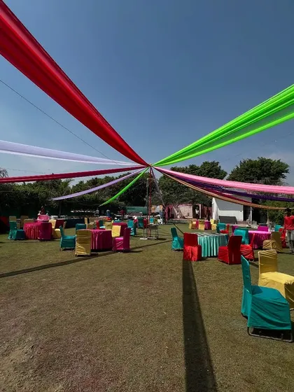 For daytime outdoor events like Mehendi or Holi parties, we set up these vibrant fabric canopies that provide shade and create a festive, colorful atmosphere for all your guests.