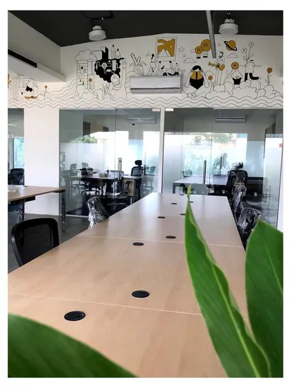 This modern co-working space was designed to foster collaboration and creativity. The open layout, glass partitions, and custom wall illustrations create a dynamic and inspiring workplace interior, ready for the post-lockdown return to office life.