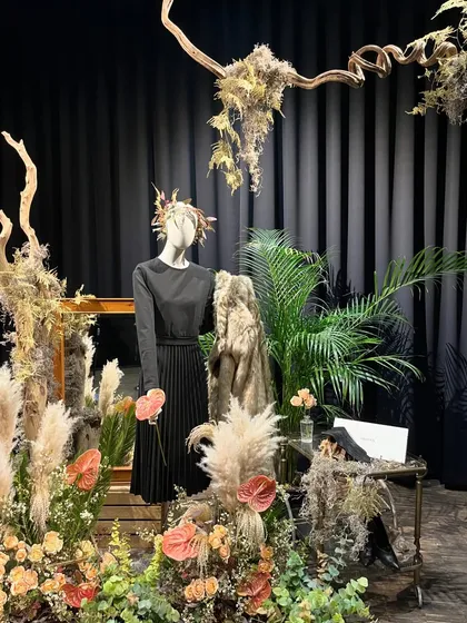 For this set design, I aimed for a look that was feminine, chic, and a little sassy. I used a palette of peaches, browns, and creams with accents of wood, pampas grass, and anthuriums to create a sophisticated and earthy environment.