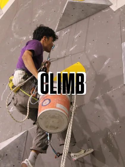 A route setter carries a bucket of holds up the wall. Each route is a puzzle, and our setters are the architects, choosing the right pieces to create a masterpiece of movement.
