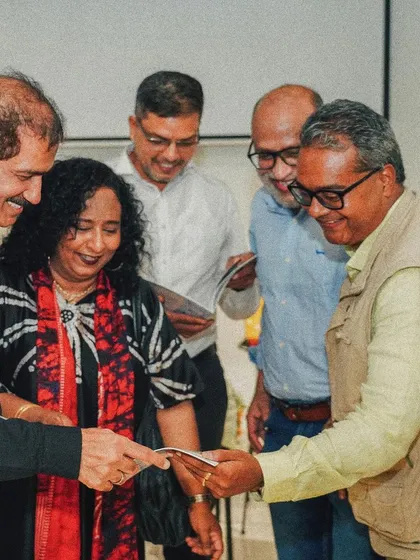 Colleagues and friends examining the newly launched book, which documents the extensive portfolio and history of OSSA.
