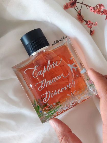 "Explore, Dream, Discover." This perfume bottle was engraved with an inspirational quote and delicate illustrations, turning it into a piece of art that reflects a personality.