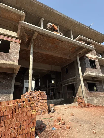 A similar view of the construction site, showing the large, open spaces that will eventually become grand living areas.