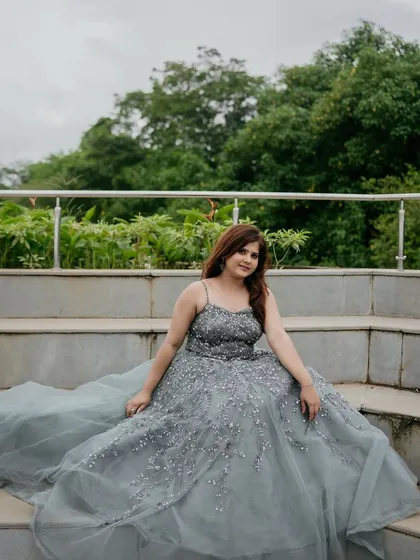 Seated in the grey-blue gown, you can see the beautiful drape of the long, flowing skirt.