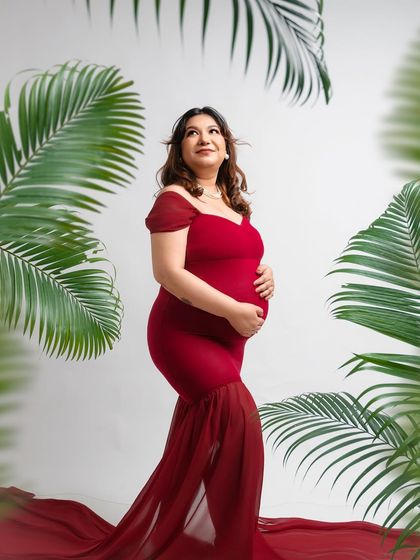 Looking up towards a new chapter. The composition of this shot, with the mother framed by leaves from above and below, creates a unique and artistic perspective.