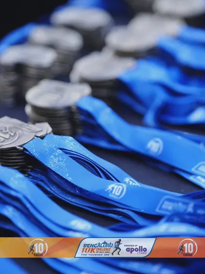 A pile of finisher medals from the Bengaluru 10K Challenge, waiting for the runners who earned them.