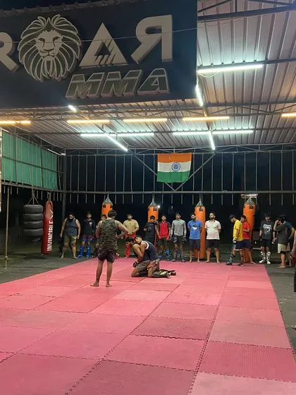 A wide view of our training ground. Here I am demonstrating a Jiu-Jitsu technique while the team watches. Every inch of this mat is a classroom for combat.