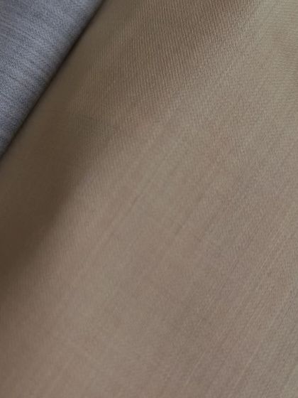 A pairing of a light grey and a beige fabric, a classic combination for a stylish and elegant look.