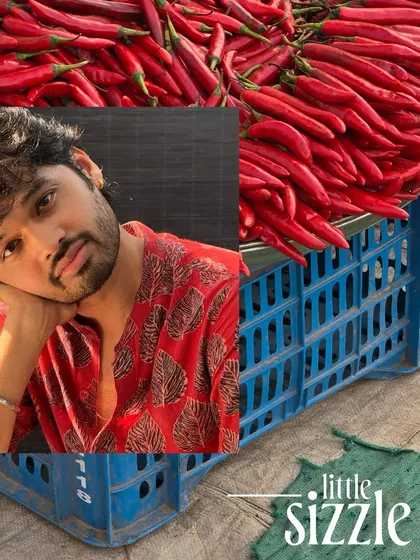 A self-portrait collage with crates of red chillies, capturing the fiery energy of the spice market.