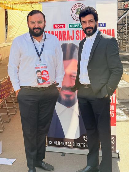 Standing with a colleague during a bar association election campaign. We support each other's ambitions.