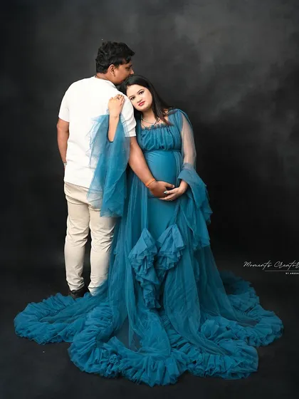 A gentle and supportive pose. The partner’s embrace from behind is a classic way to showcase their unity and shared excitement.