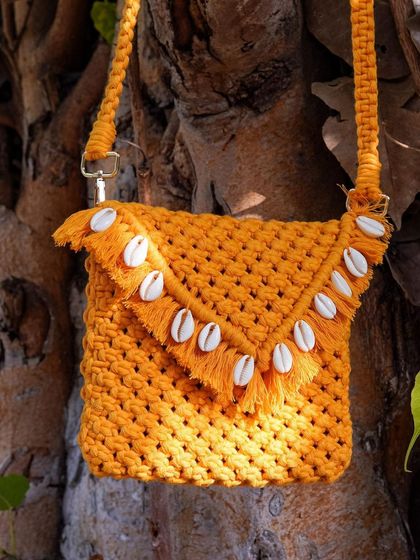 Another angle of this gorgeous mustard and sea shell crossbody bag. I love how the color pops against the tree. It really shows off the handmade texture and the quality of the recycled cotton cord I use.