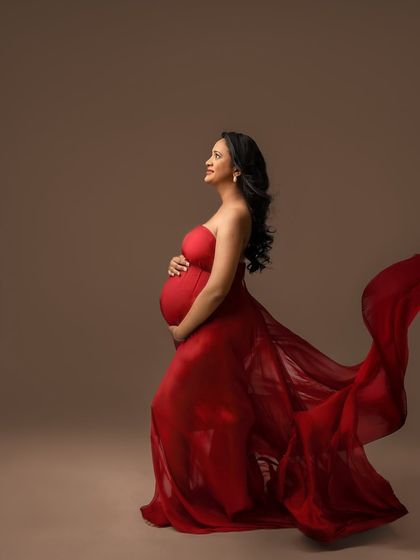 Looking up with hope and joy. The movement in this red fabric adds a sense of freedom and power to the portrait.