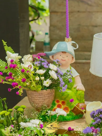 Another sweet figurine used as a centerpiece. This little character holding a flower basket adds a playful and innocent touch, perfect for a baby shower theme.