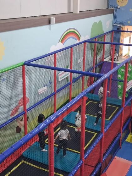 A wide view of our long trampoline section, where multiple kids can jump at once, all protected by high safety nets.