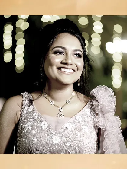 A beautiful smile captured against a backdrop of bokeh lights. Her lavender reception look is truly magical.