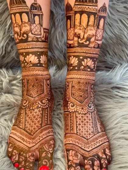 Bridal mehndi isn't complete without beautiful designs for the feet. This piece showcases intricate patterns with elephants and architectural domes, designed to complement the bride's hand mehndi and complete her look.