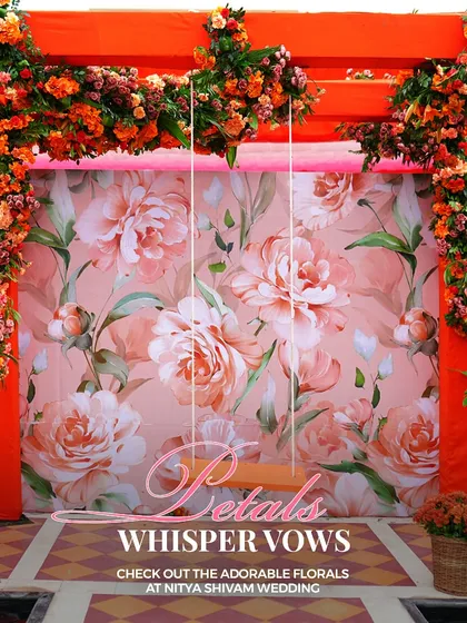 A photo booth with a floral-printed backdrop and an orange frame, perfect for capturing fun memories. The swing adds a playful element for guests.