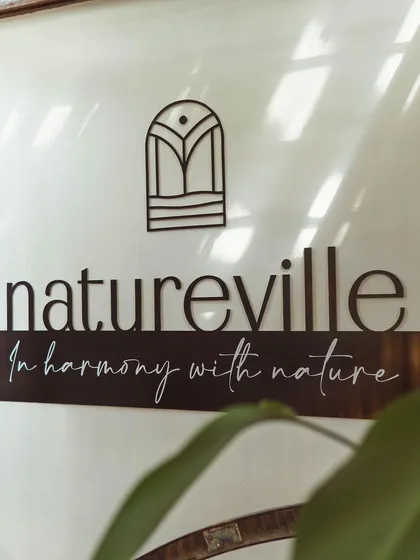 A detail shot of our "In harmony with nature" sign, a daily reminder of our core mission.