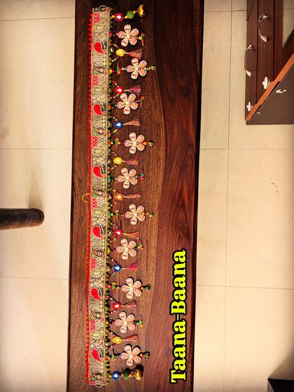 A full-length view of the 'Taana Baana' toran, showing off its 48-inch-long, perfectly imperfect design. It's a great example of how handmade items have a unique soul.