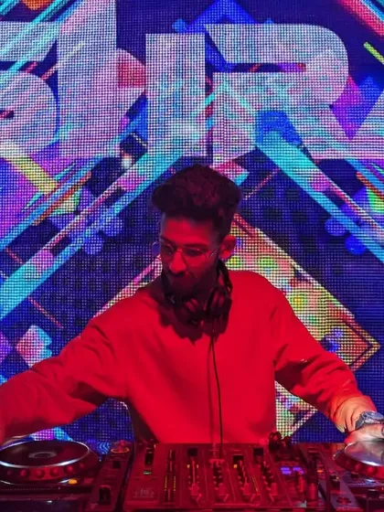 On the decks during the Bollywood Festival 2023. The vibrant visuals on the screen behind me are part of the immersive experience I create, syncing with my custom Bollywood EDM remixes.