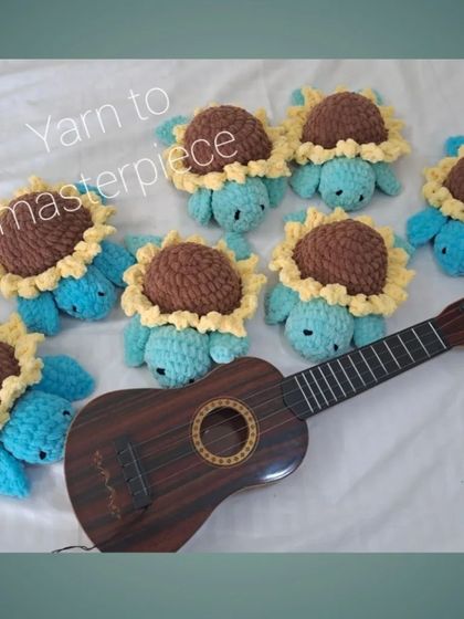 A group of the blue sunflower turtles posing with a ukulele.