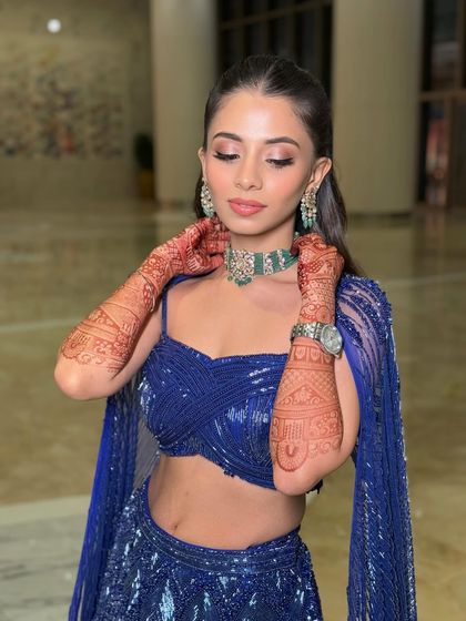 A close-up of the sister of the bride's cocktail look. The focus is on the clean, winged eyeliner and soft pink eyeshadow, paired with a flawless matte base.