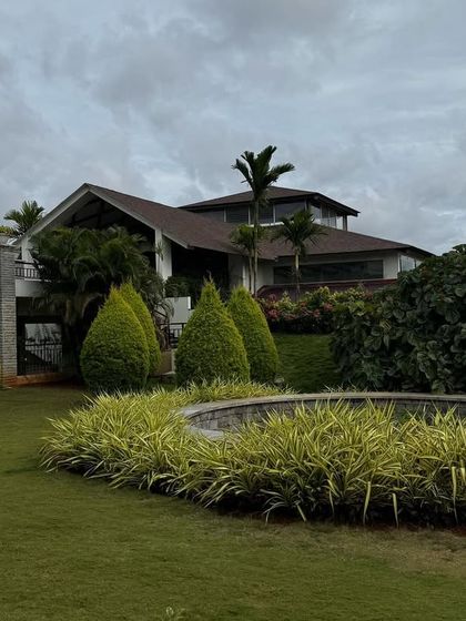 The garden fountain and main building under a cloudy sky. The sound of the water and the cool weather create a deeply relaxing atmosphere.