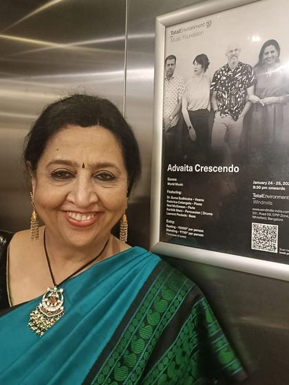 A big smile next to the poster for my 'Advaita Crescendo' concert. I was so excited for this show and to share our music with everyone.