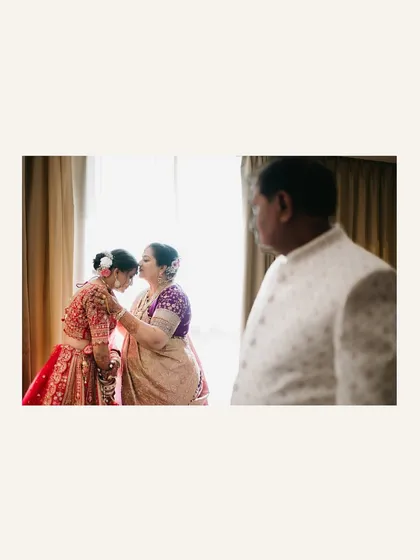 An emotional moment between the bride and her mother, sharing a quiet blessing before the wedding ceremony.