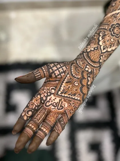 The palm of bride Madeeha, featuring her name beautifully written in Urdu calligraphy.